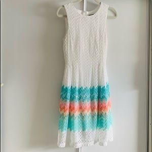 The dress has , teal color with pink , orange, peach, & white